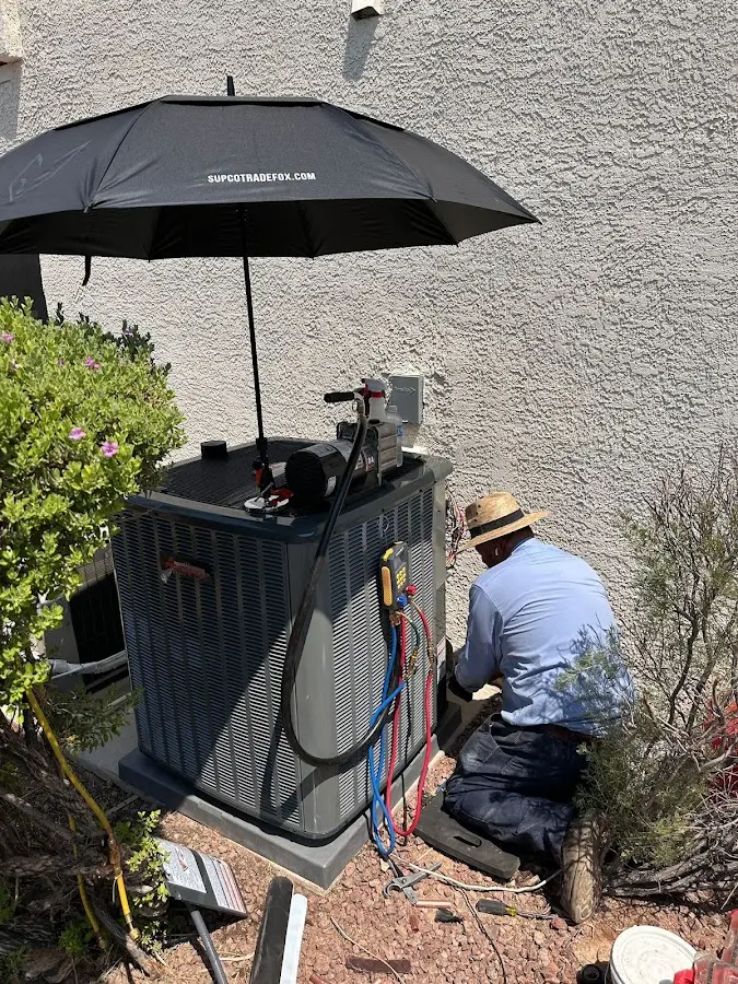 HVAC technician performing outdoor AC maintenance in Los Gatos